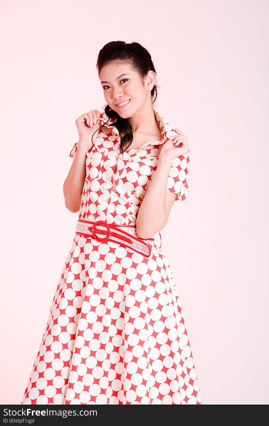 Girl in a red dress with white dots with an expressive face and gesture. Girl in a red dress with white dots with an expressive face and gesture