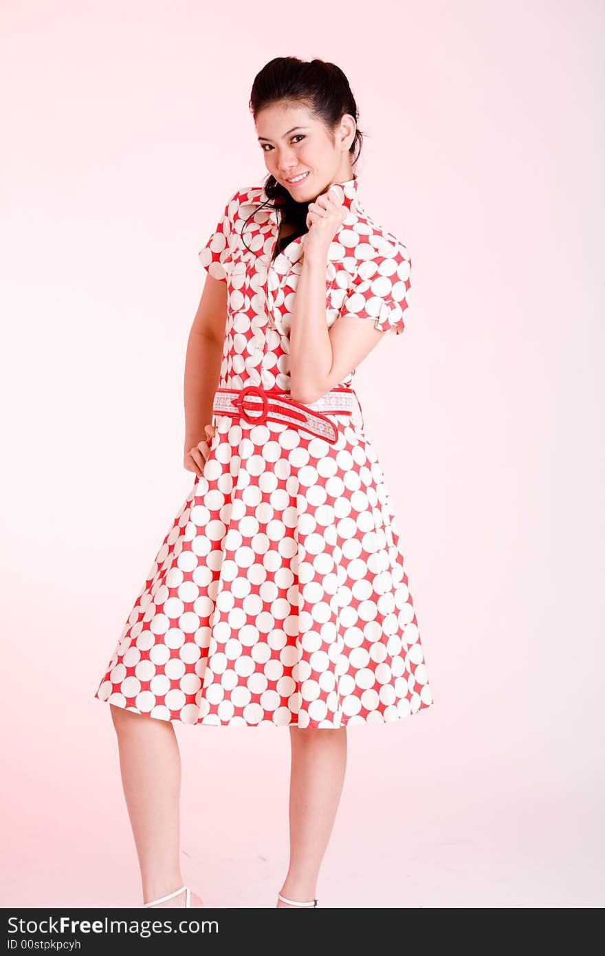 Girl in a red dress with white dots with an expressive face and gesture. Girl in a red dress with white dots with an expressive face and gesture