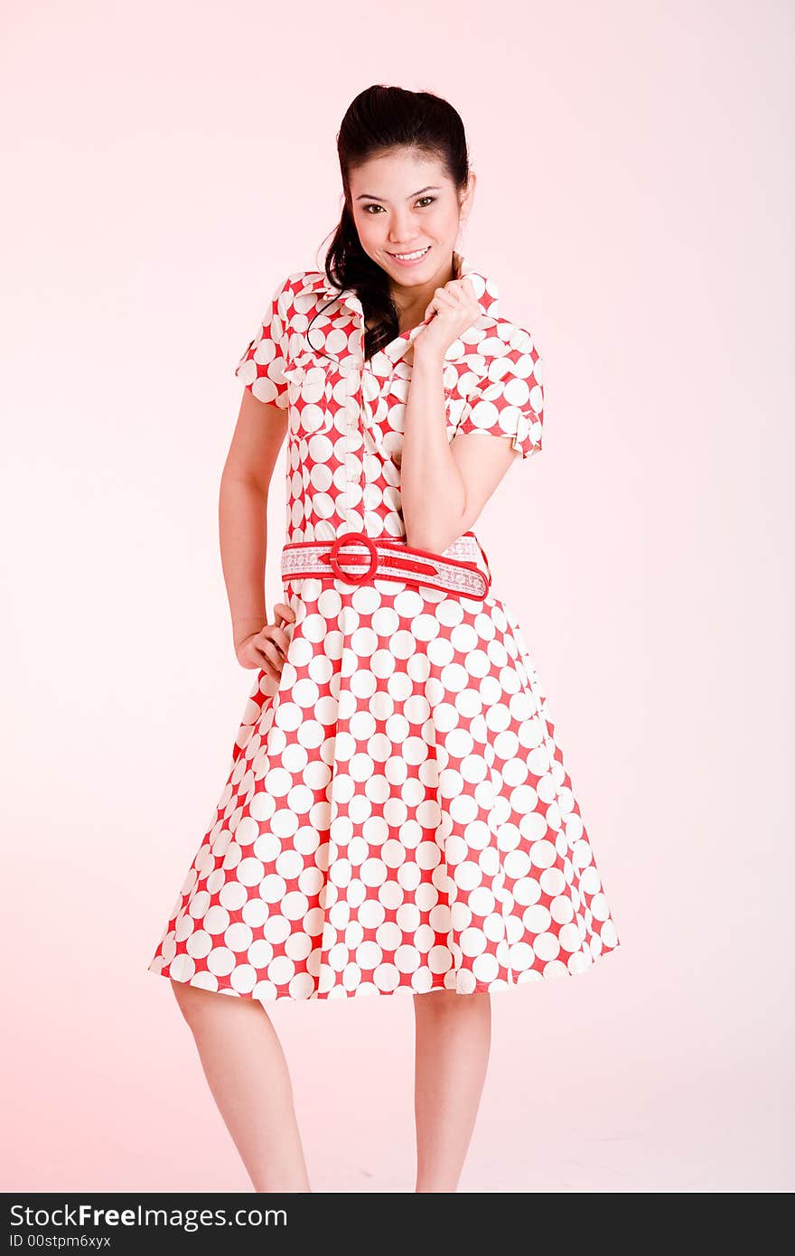 Girl in a red dress with white dots with an expressive face and gesture. Girl in a red dress with white dots with an expressive face and gesture