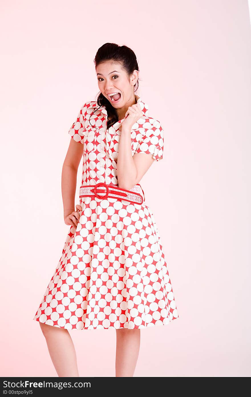 Girl in a red dress with white dots with an expressive face and gesture. Girl in a red dress with white dots with an expressive face and gesture