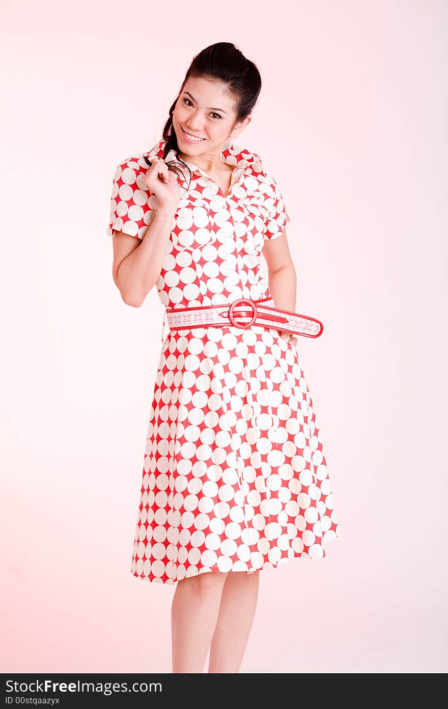 Girl in a red dress with white dots with an expressive face and gesture. Girl in a red dress with white dots with an expressive face and gesture