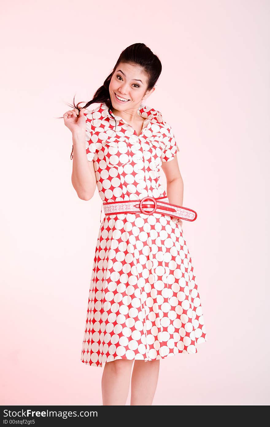 Girl in a red dress with white dots with an expressive face and gesture. Girl in a red dress with white dots with an expressive face and gesture