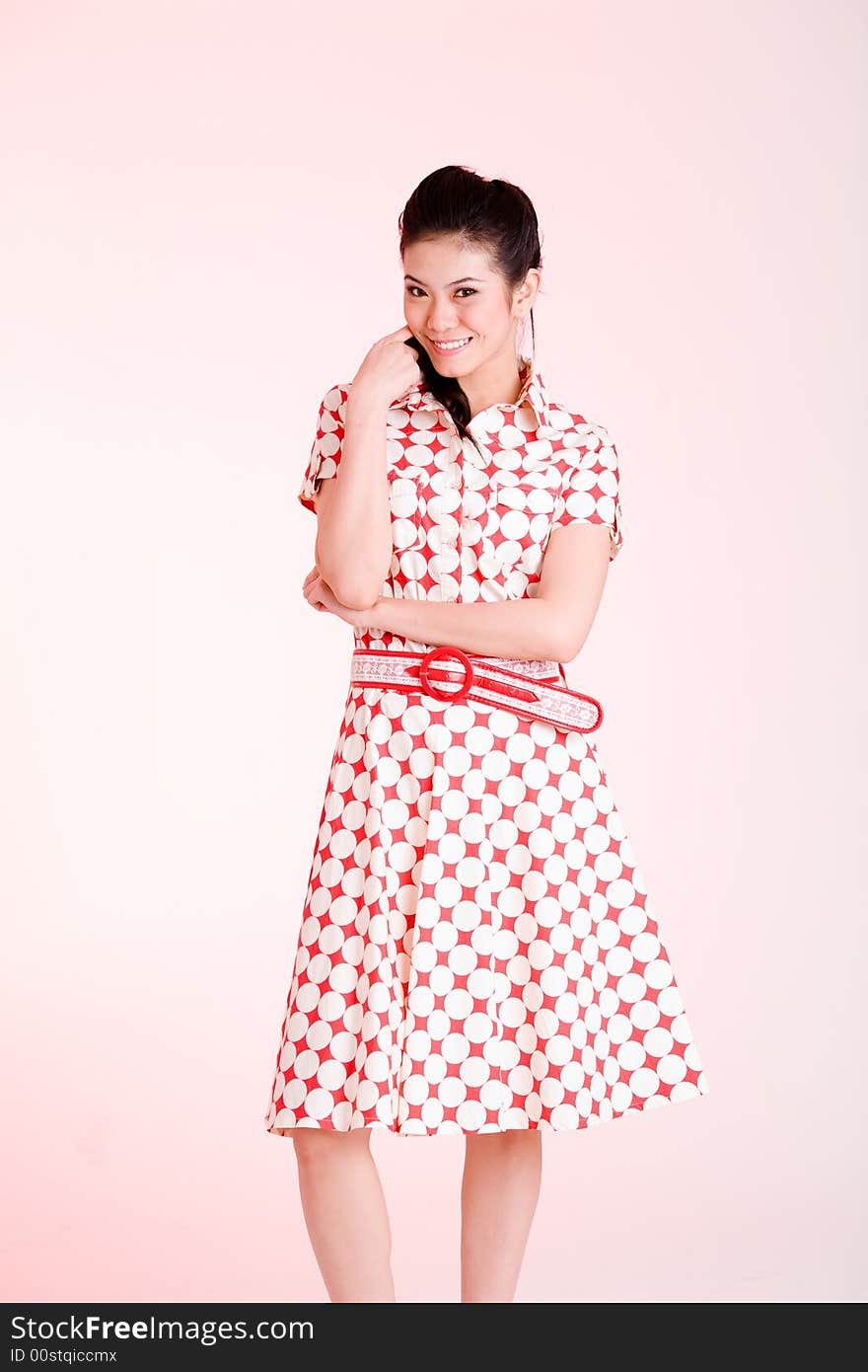 Girl in a red dress with white dots with an expressive face and gesture. Girl in a red dress with white dots with an expressive face and gesture