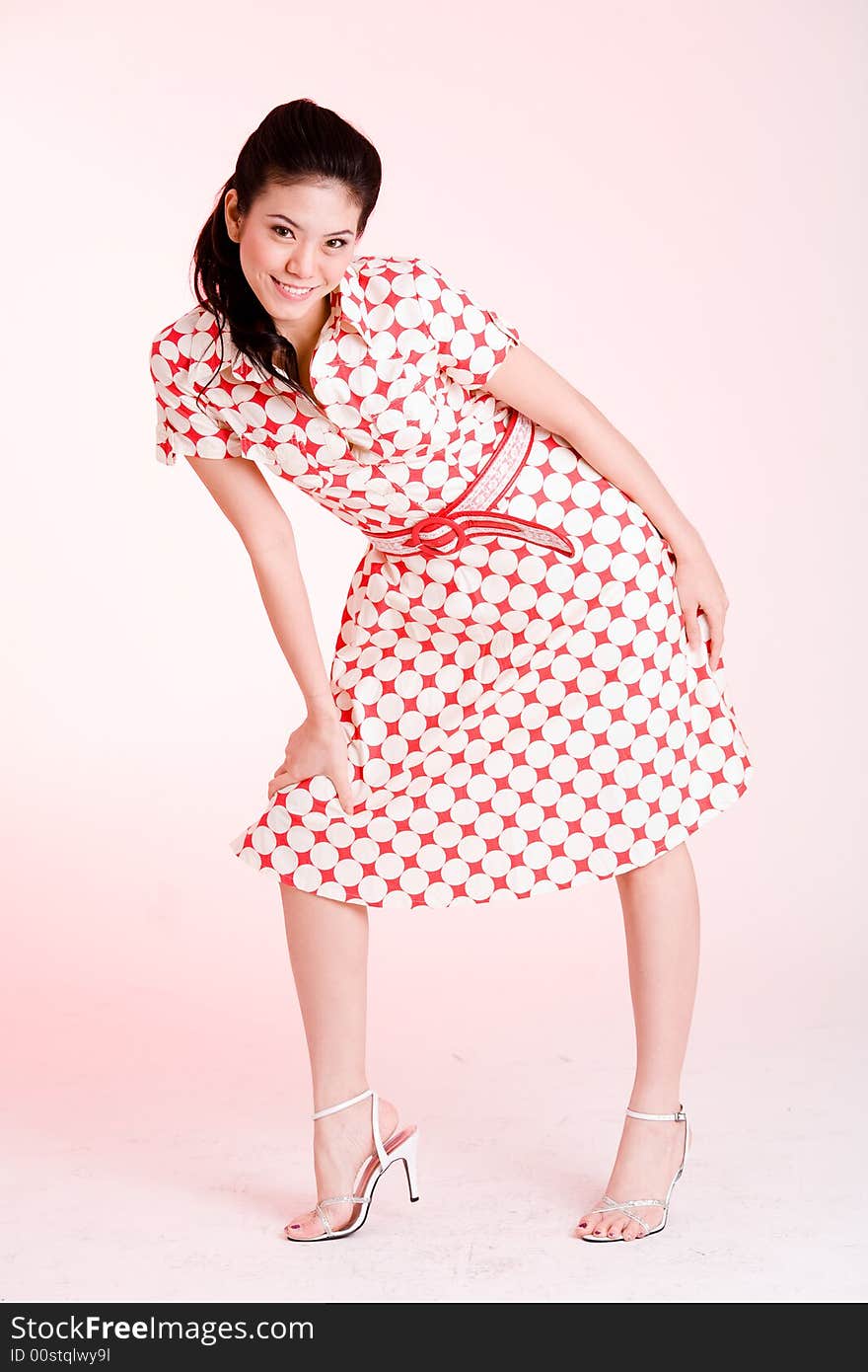 Girl in a red dress with white dots with an expressive face and gesture. Girl in a red dress with white dots with an expressive face and gesture