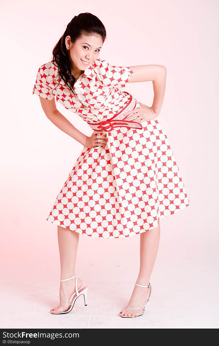 Girl in a red dress with white dots with an expressive face and gesture. Girl in a red dress with white dots with an expressive face and gesture