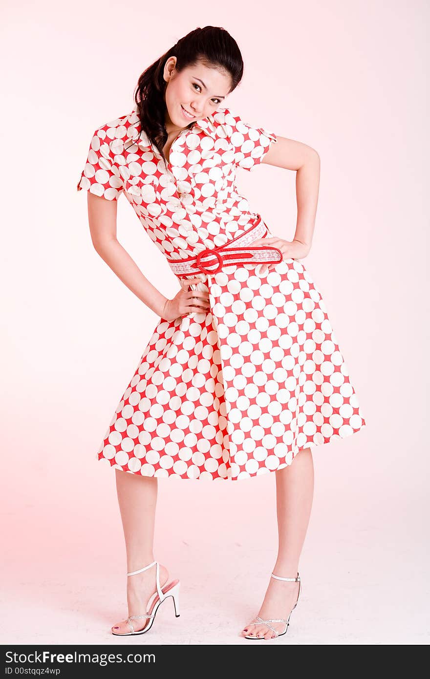 Girl in a red dress with white dots with an expressive face and gesture. Girl in a red dress with white dots with an expressive face and gesture