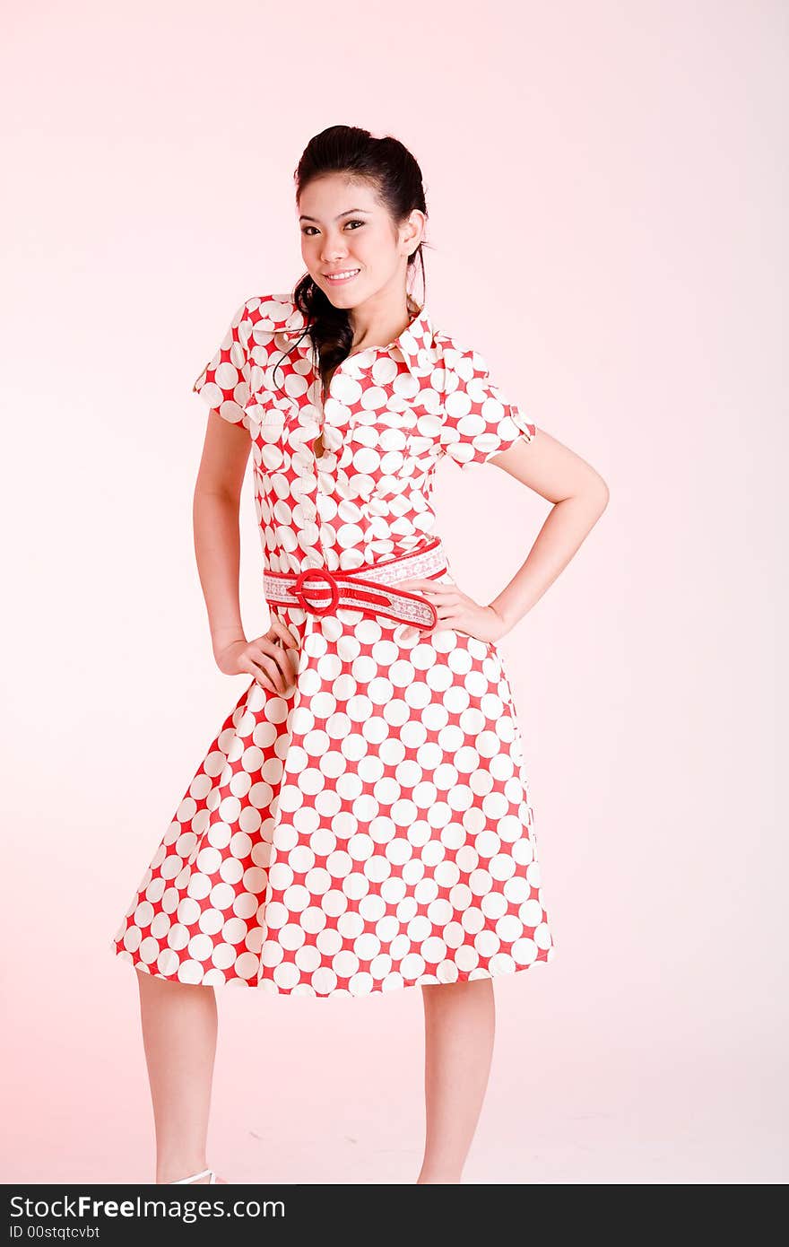 Girl in a red dress with white dots with an expressive face and gesture. Girl in a red dress with white dots with an expressive face and gesture