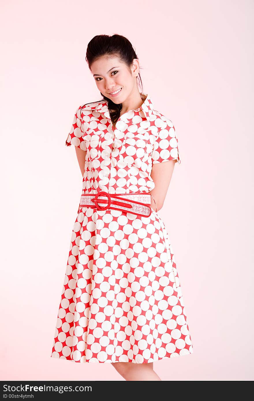 Girl in a red dress with white dots with an expressive face and gesture. Girl in a red dress with white dots with an expressive face and gesture