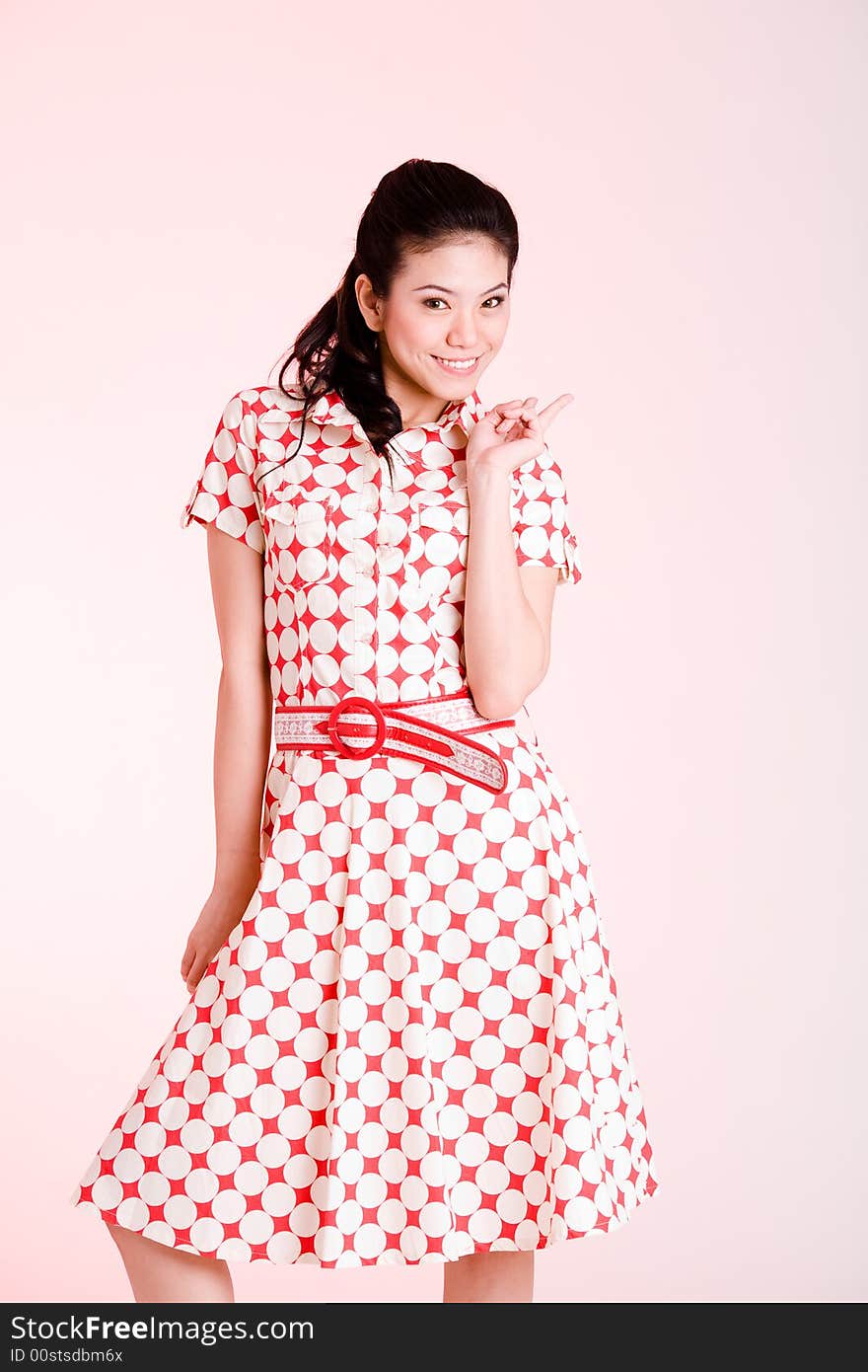 Girl in a red dress with white dots with an expressive face and gesture. Girl in a red dress with white dots with an expressive face and gesture