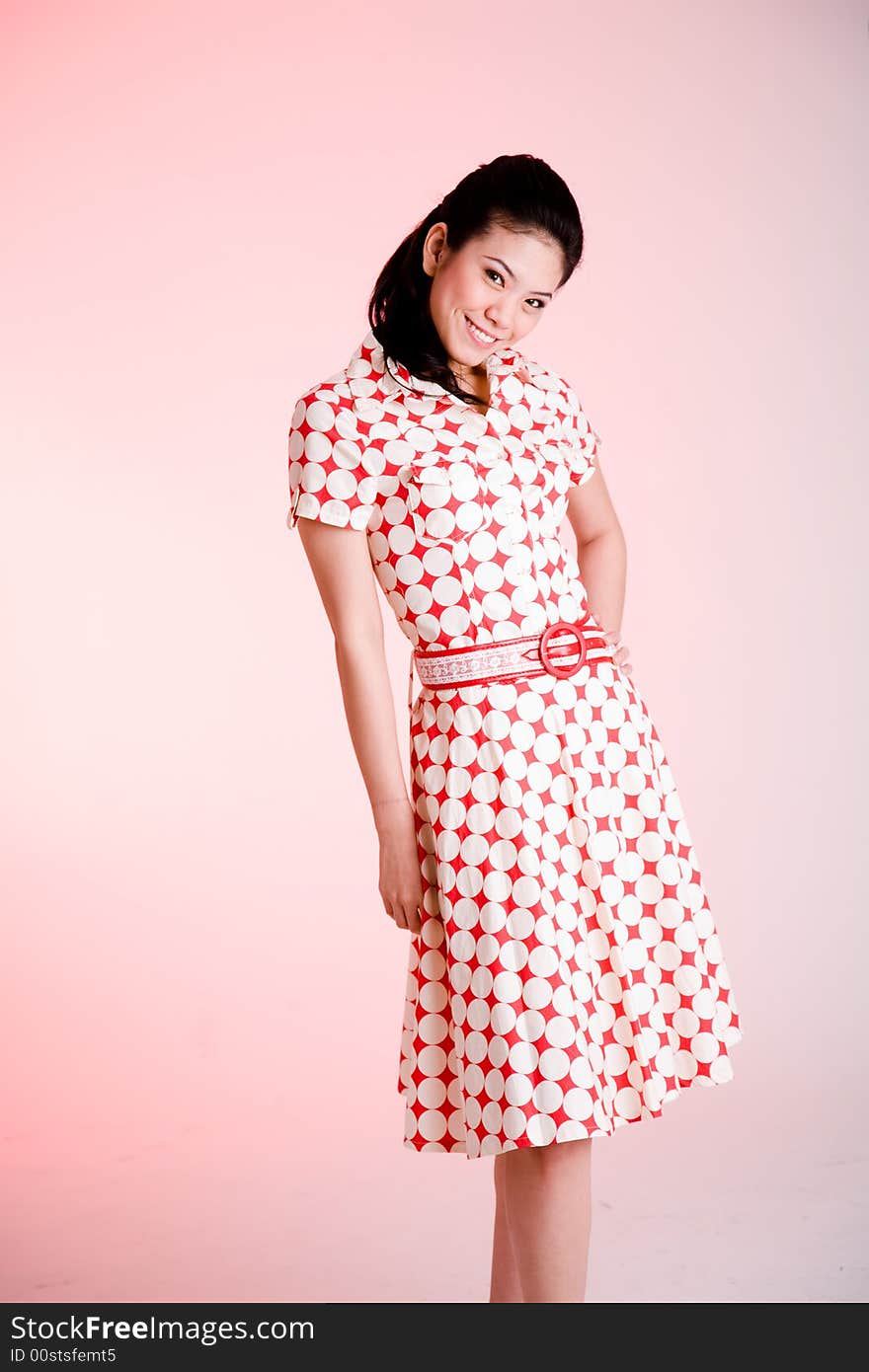 Girl in a red dress with white dots with an expressive face and gesture. Girl in a red dress with white dots with an expressive face and gesture