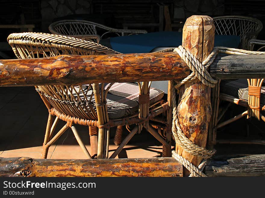 Wooden fence and rope and bamboo chair on black background