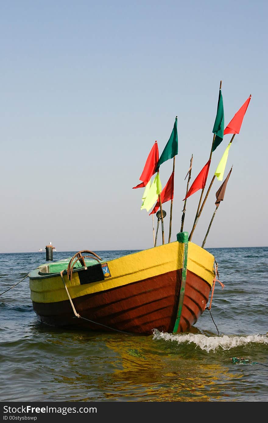 Fisherman boat with flags in sea