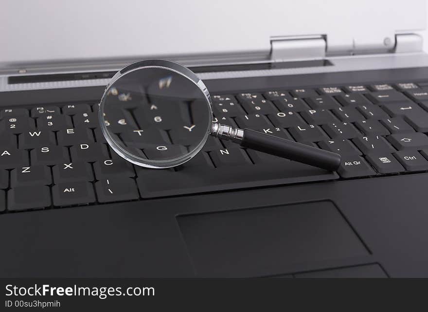 Laptop with a magnifying glass - security concept. Laptop with a magnifying glass - security concept