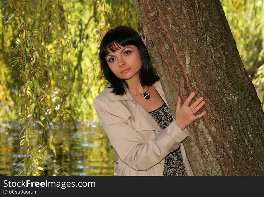 Beautiful woman staying in front of the lake. Beautiful woman staying in front of the lake