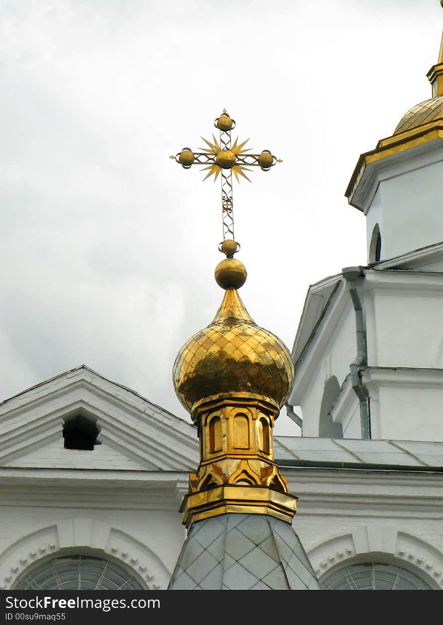 Church golden cupola with reach decorated cross