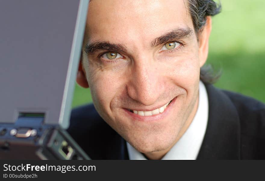 Confident and successful young adult businessman working on his laptop computer