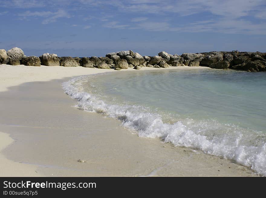 Rocks along beach cove in coco cay bahamas