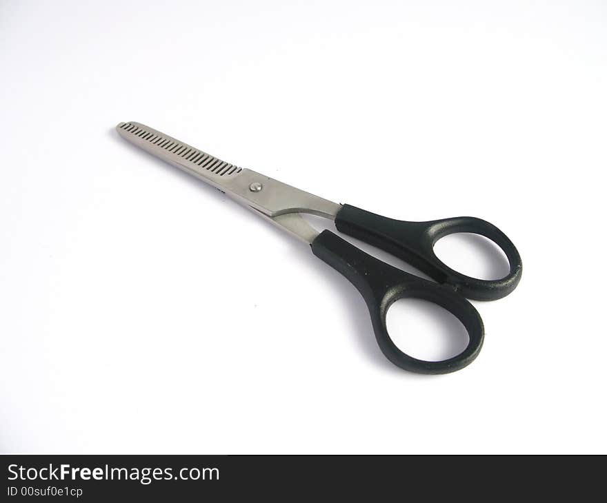 Haircutting scissors on white background