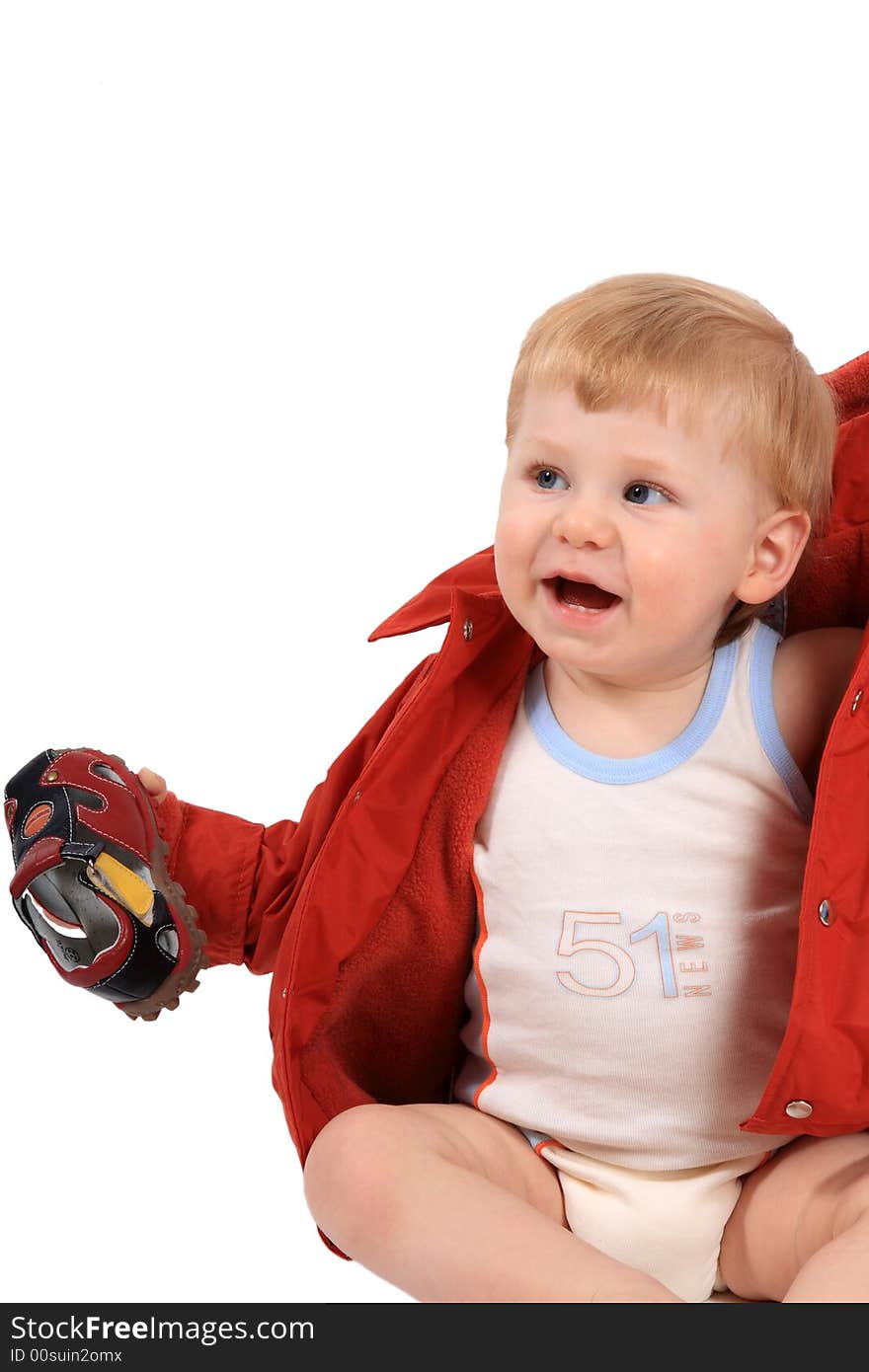 The beautiful little boy tries on footwear. The beautiful little boy tries on footwear