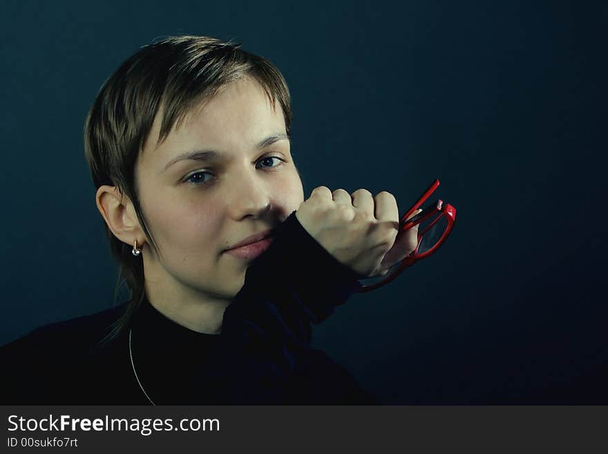 Portrait of a young pretty woman with the red glasses. Portrait of a young pretty woman with the red glasses