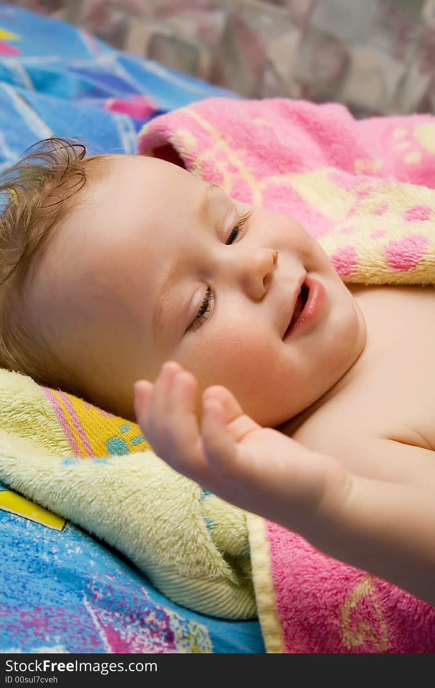 Baby after the bath under towel