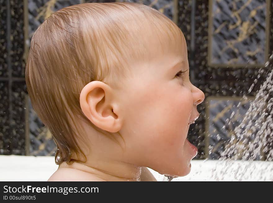 Bathing and smiling baby under the douche. Bathing and smiling baby under the douche