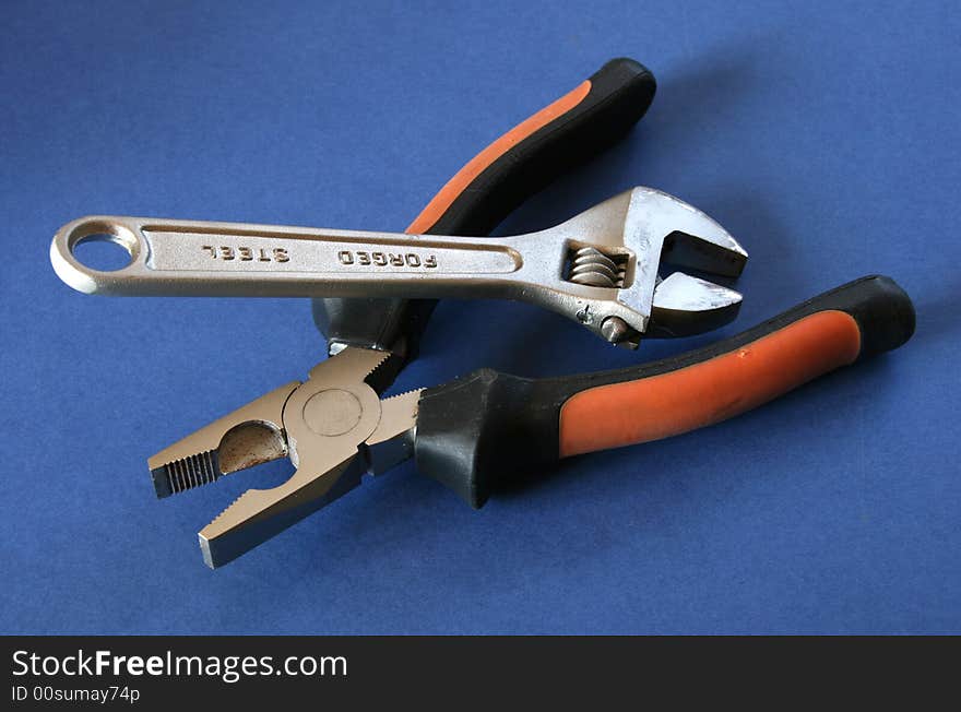 Two different tools over a blue background. Two different tools over a blue background