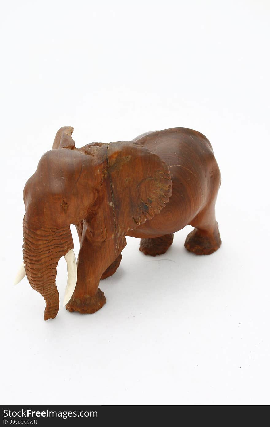 A wooden elephant carved by the local people isolated on a white background. A wooden elephant carved by the local people isolated on a white background