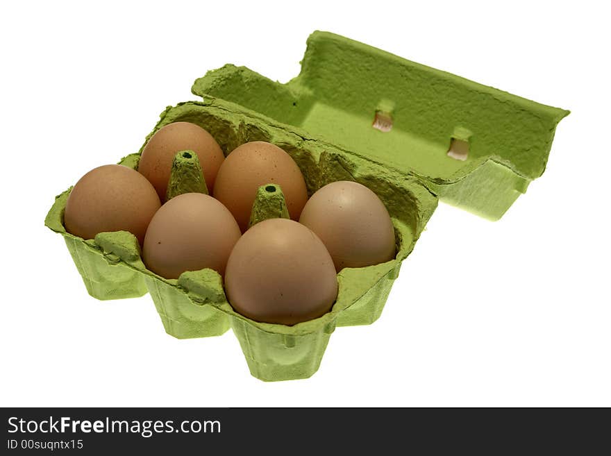 Eggs in an egg carton over white.