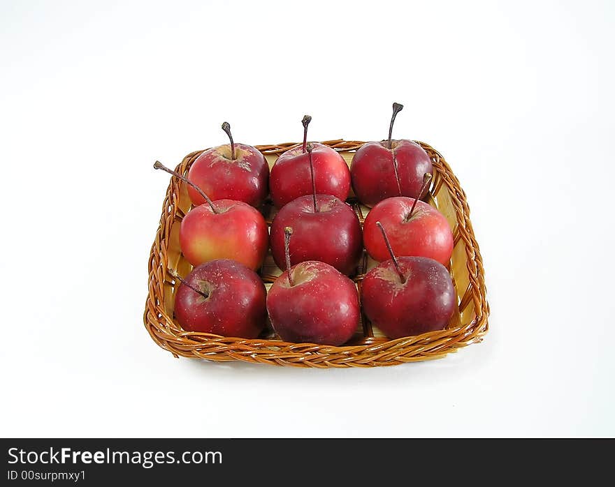 Red apples in a straw basket. isolated.