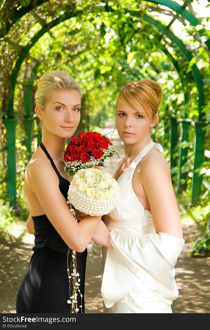 Two girls with a flowers in green alley