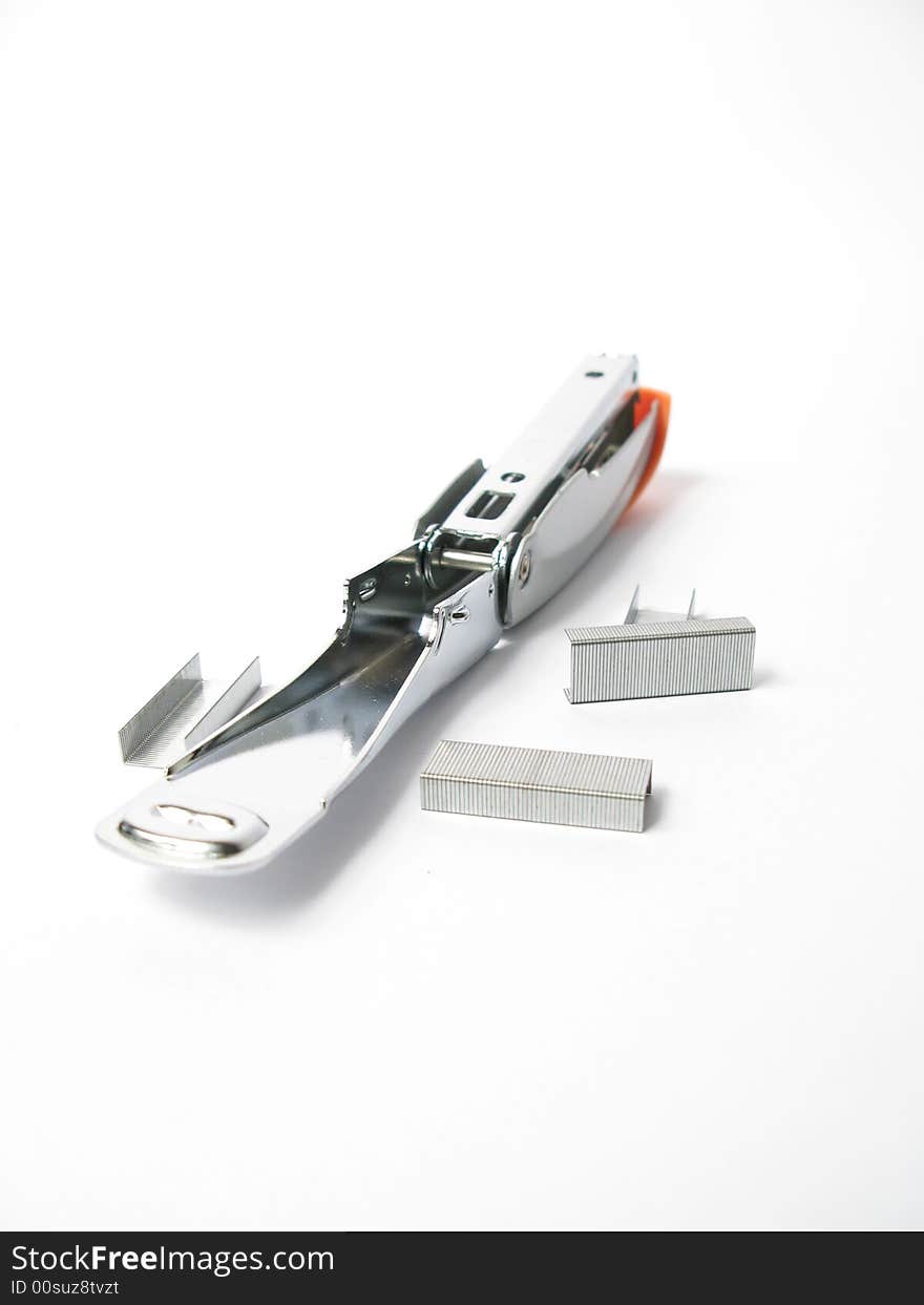 Silver and orange Stapler with staples on white background. Silver and orange Stapler with staples on white background