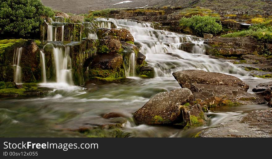 Evening panorama of a falls in mountains