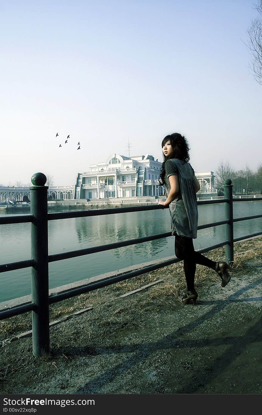 In a park of Beijing, A beautiful Chinese girl is enjoying the scenery in pleasant early spring here. In a park of Beijing, A beautiful Chinese girl is enjoying the scenery in pleasant early spring here.