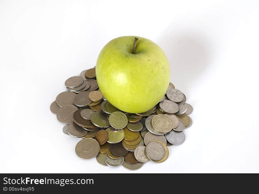 Green apple on the heap of coins. Green apple on the heap of coins