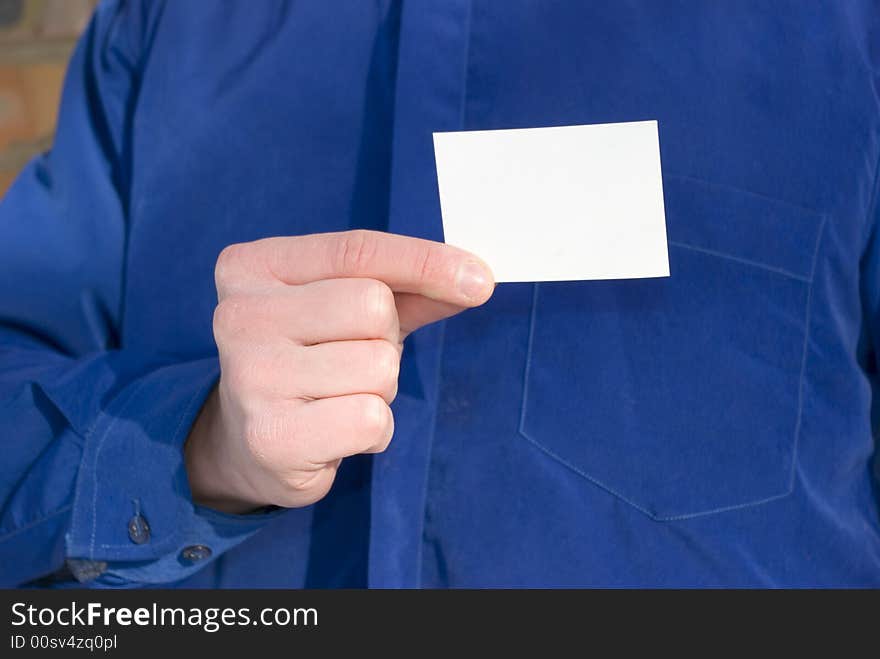 Blank card in hand isolated on blue background