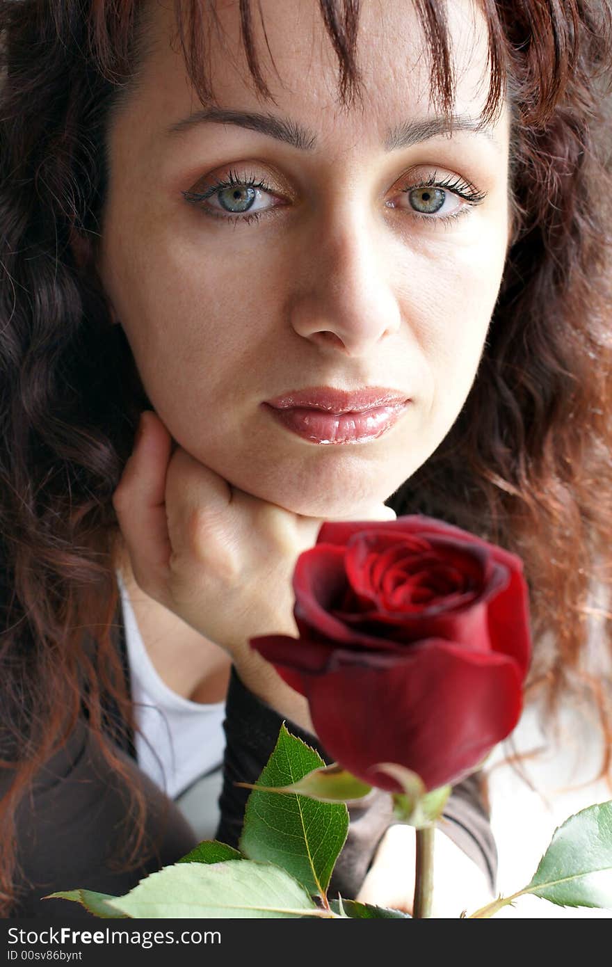 Beautiful brunette woman and a flower. Beautiful brunette woman and a flower