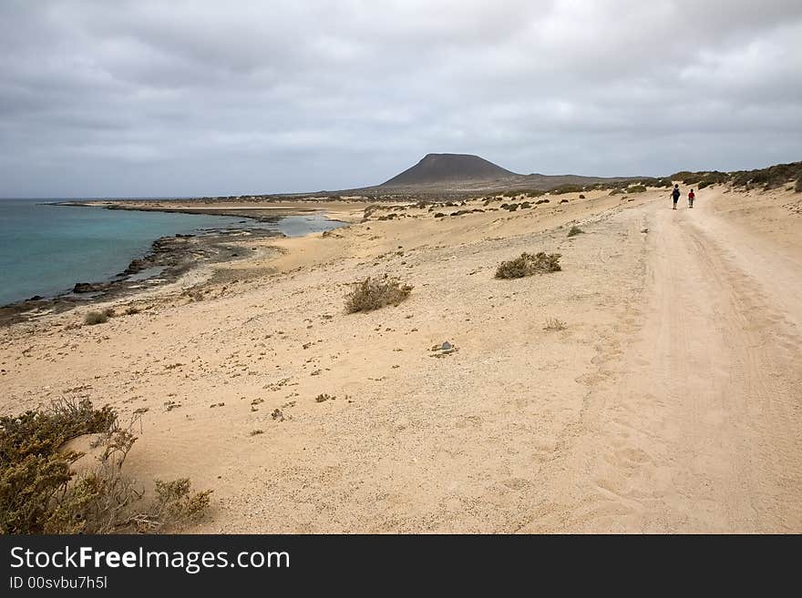 Walking towards Monta�a Amarilla in La Graciosa island, Canary Islands, Spain. Walking towards Monta�a Amarilla in La Graciosa island, Canary Islands, Spain