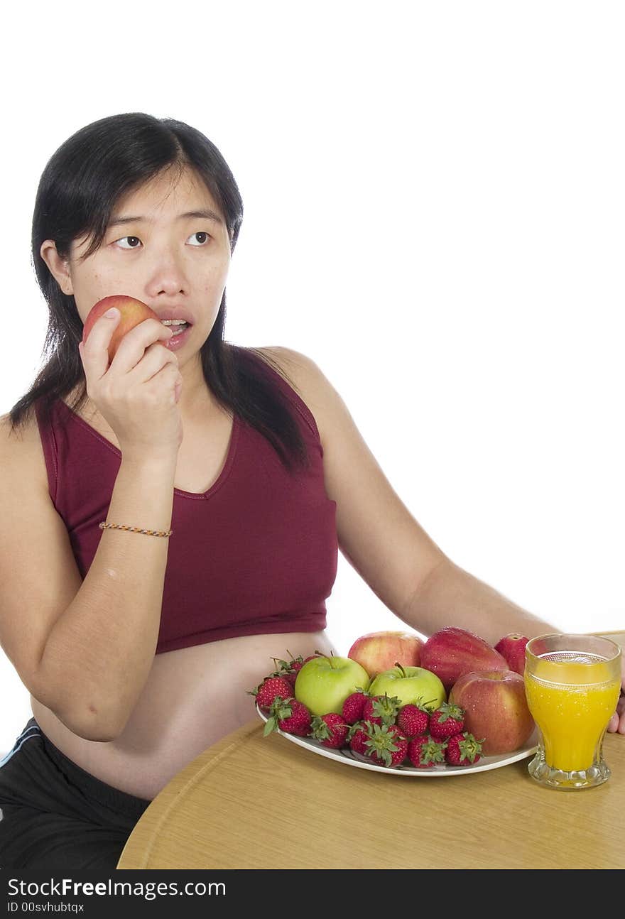 A pregnant women eat her apple with white background