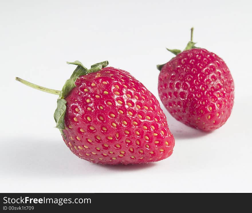 Two strawberry close up with white background