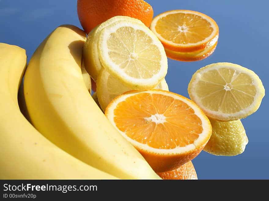 Different fruits with reverberation in sunlight on blue background. Different fruits with reverberation in sunlight on blue background