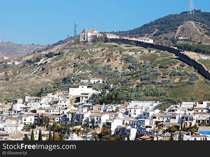 Cave dwellings occupy the hillside as the poor live in these shanties above this neighborhood in Granada, Spain. Cave dwellings occupy the hillside as the poor live in these shanties above this neighborhood in Granada, Spain.