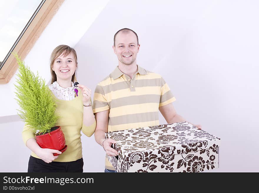 Portrait of young smiling couple in their new home.