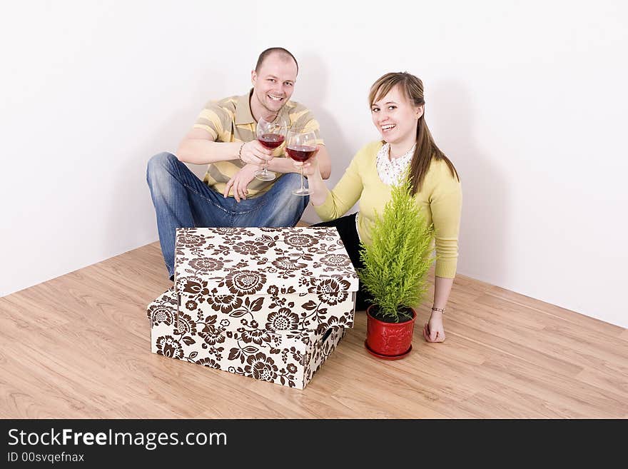 Portrait of young smiling couple in their new home.