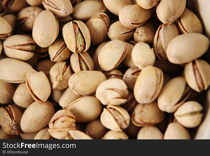 Top view of a full plate of pistachoi nuts. Top view of a full plate of pistachoi nuts.