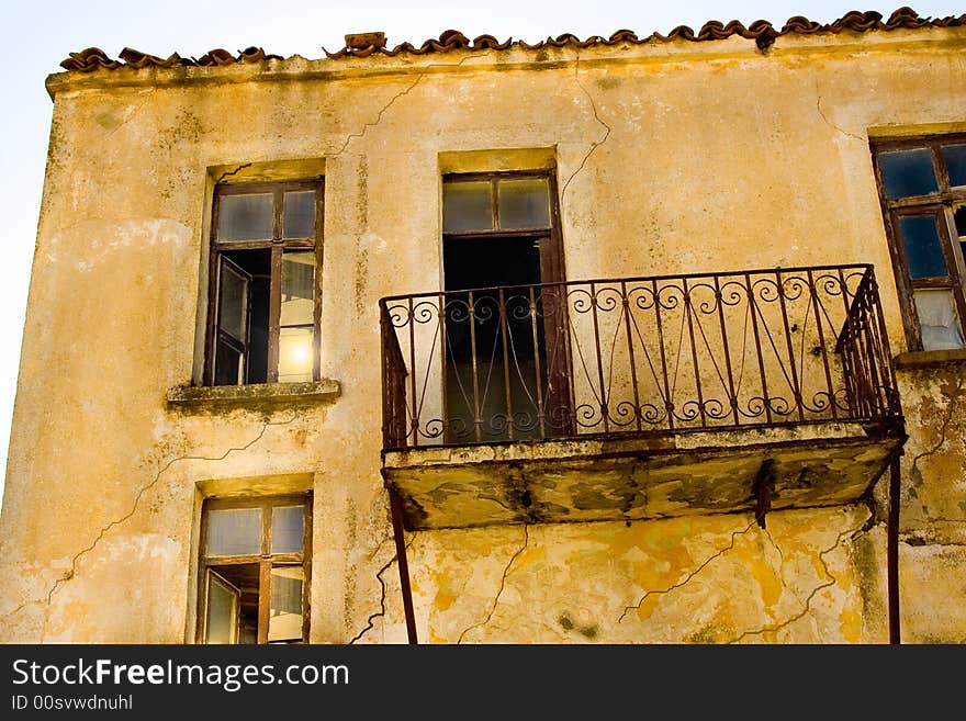 Vintage window, color picture. Ghost town detail.An aged greek house. Vintage window, color picture. Ghost town detail.An aged greek house