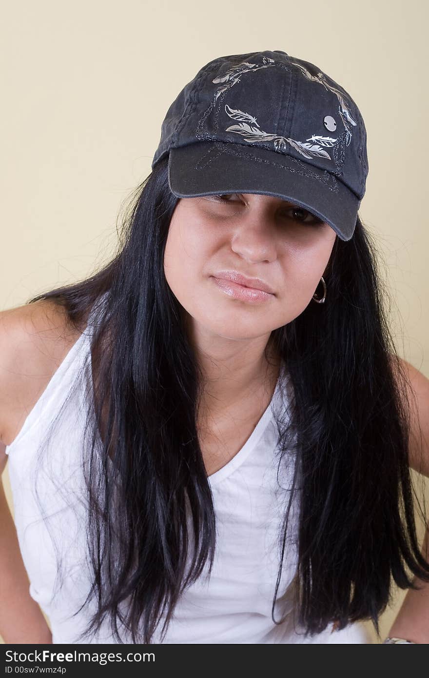 Black hair young woman in cap portrait. studio shot.