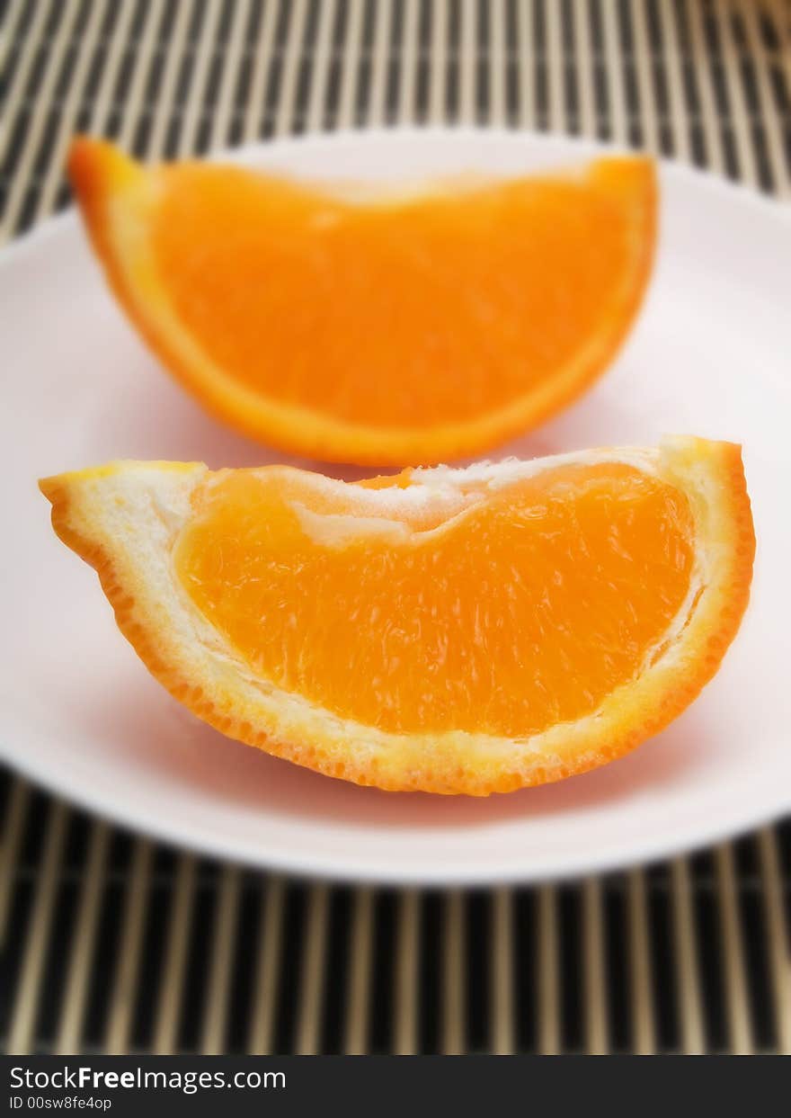 Orange slice on  a white plate