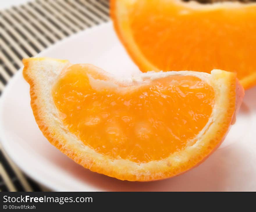 Orange slice on  a white plate