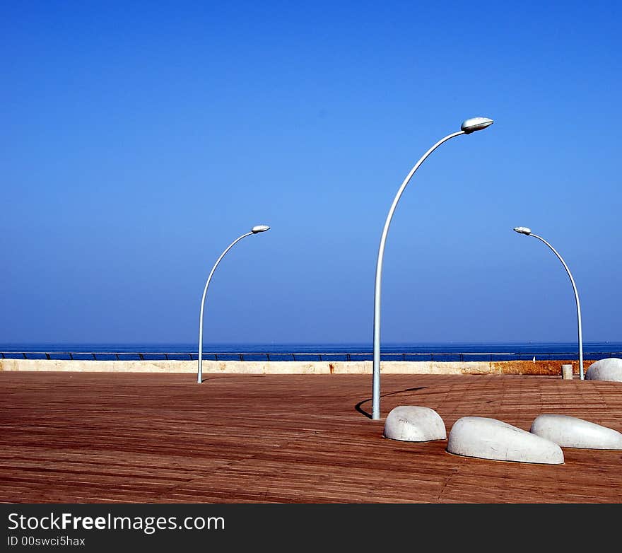 Shore of sea and three lanterns and blue sky